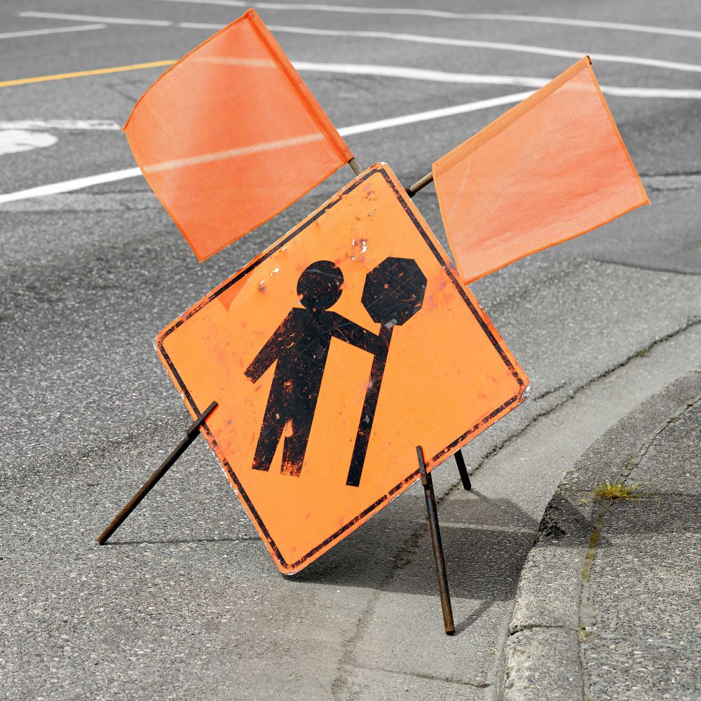 Construction flagger ahead sign on a street